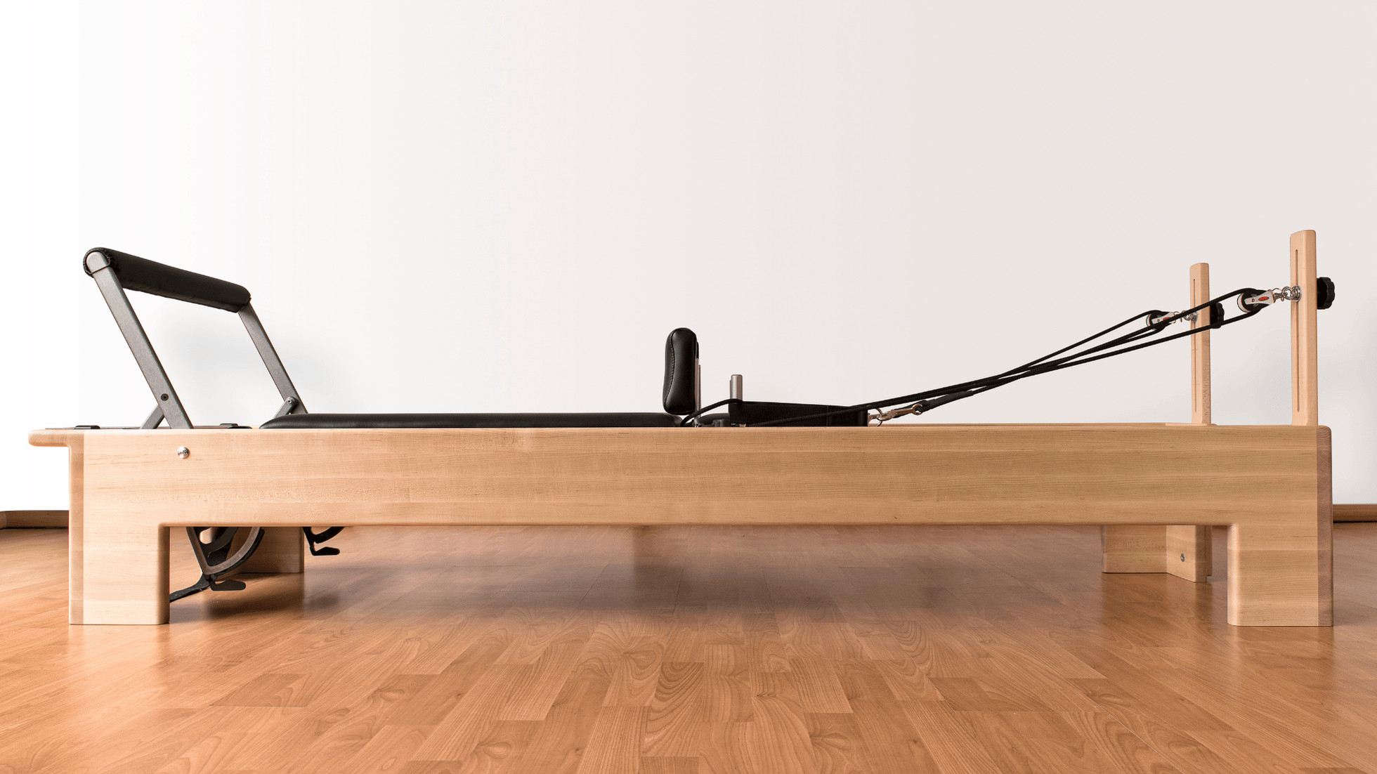 Pilates reformer with wooden frame
